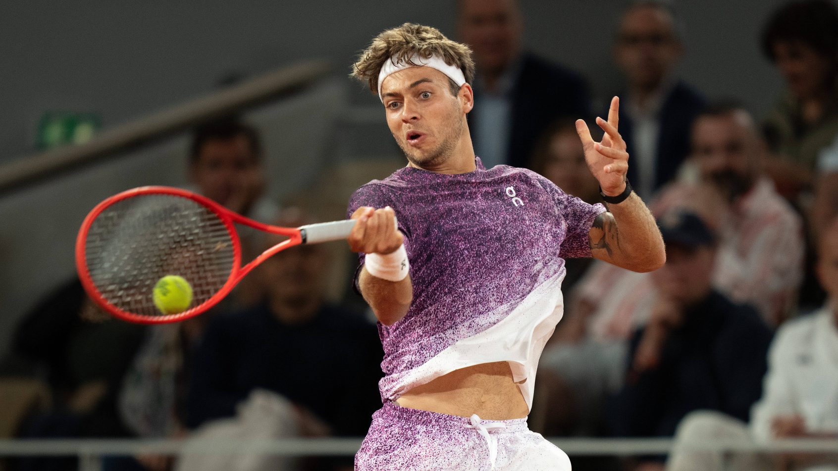 Flavio Cobolli of Italy returns a shot during his match against Felix Auger-Aliassime