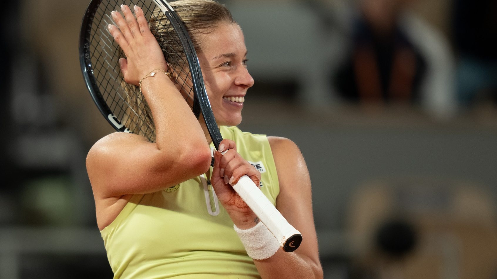 Maja Chwalinska holds racket to side of her head