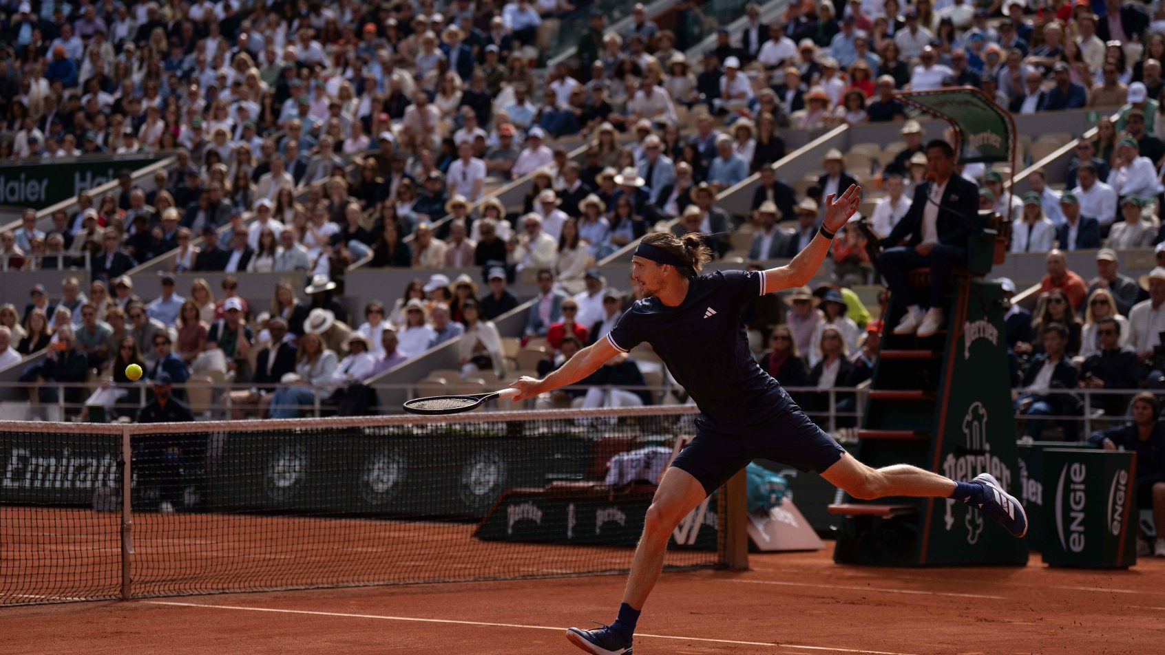 Alexander Zverev stretches to hit a backhand