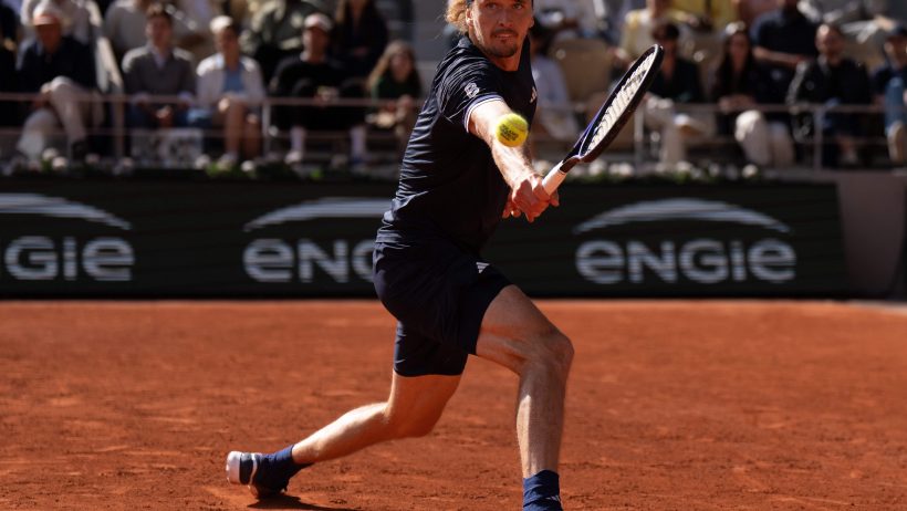 Alexander Zverev stretches to hit a backhand