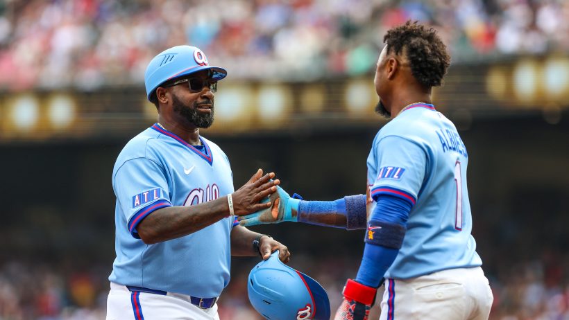 The Braves celebrate after scoring a run versus the Pirates.