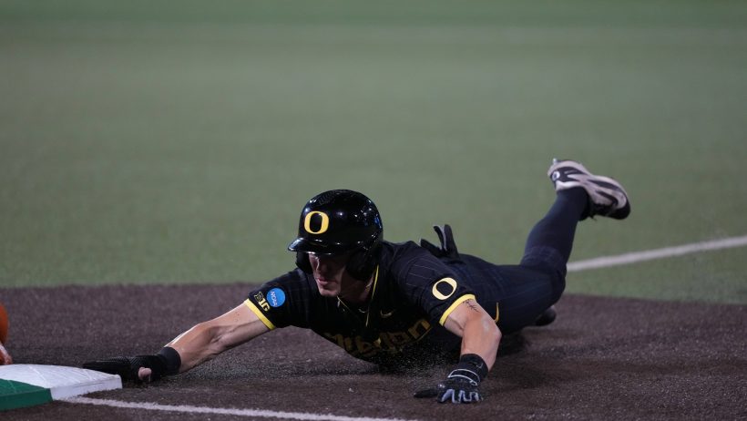 Maddox Malony dives into third base during Game 1 of the Super Regional versus Texas.
