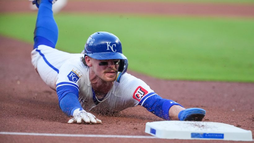 Bobby Witt Jr. slides safely into third against the Rangers.