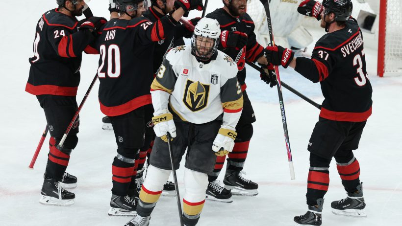 The Hurricanes celebrate a goal in front of Brayden McNabb.