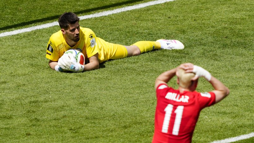 Bosnia and Herzegovina's Nikola Vasilj makes a save as Canada's Liam Millar reacts