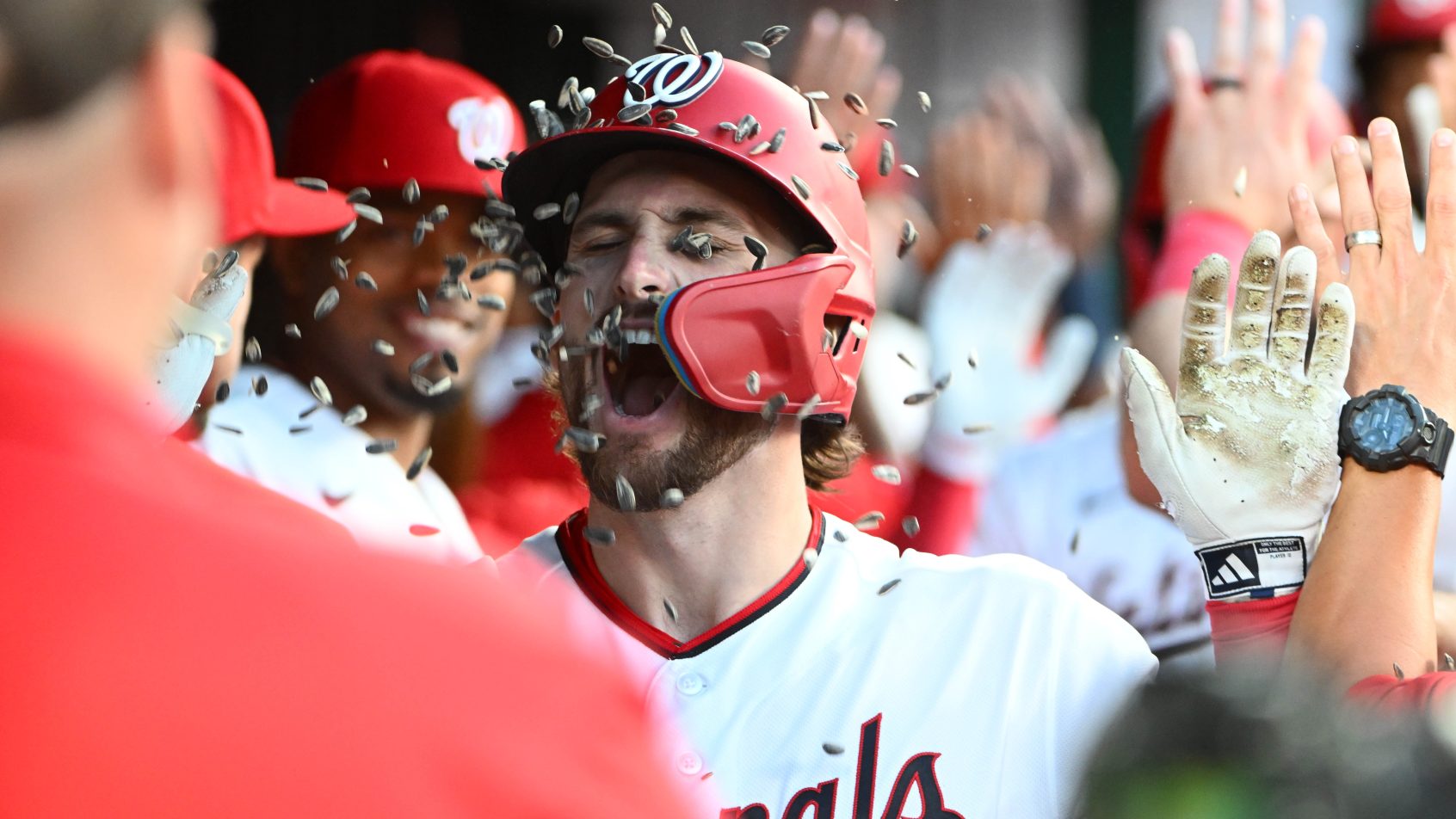 Dylan Crews celebrates a home run in the Nationals dugout.