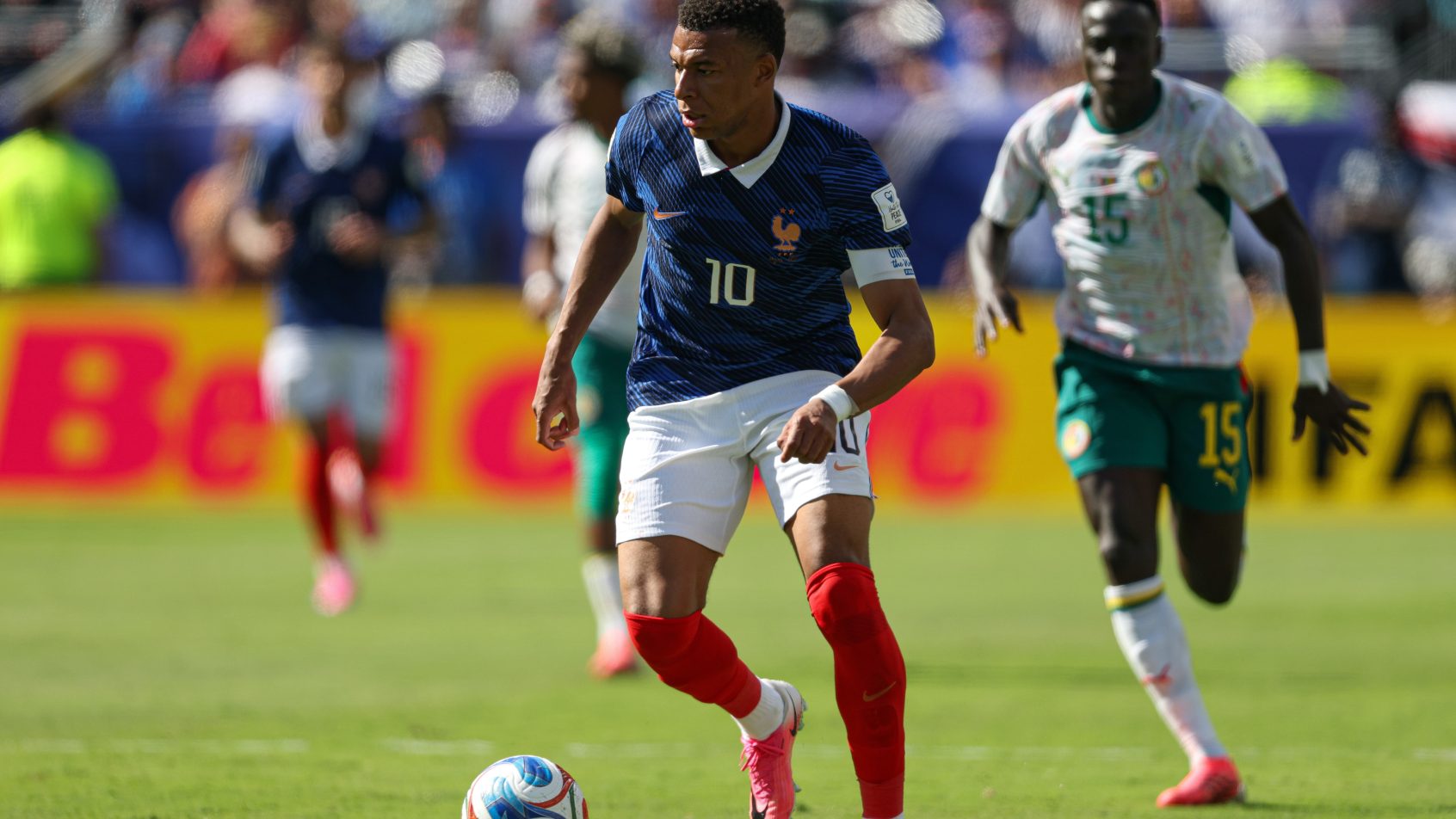 Kylian Mbappe advances the ball vs Senegal at the World Cup.