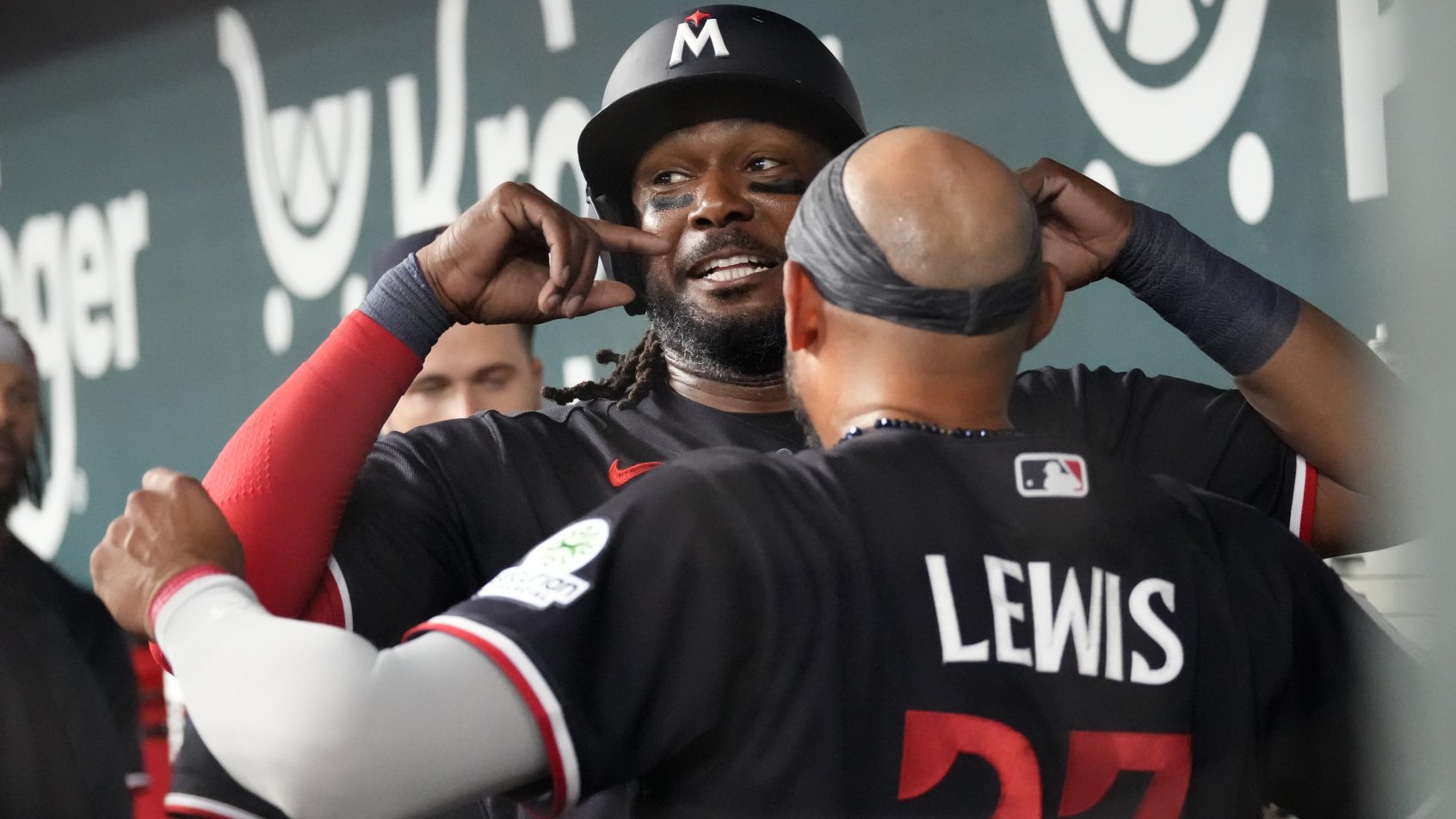 The Twins dugout celebrates a run versus the Rangers.