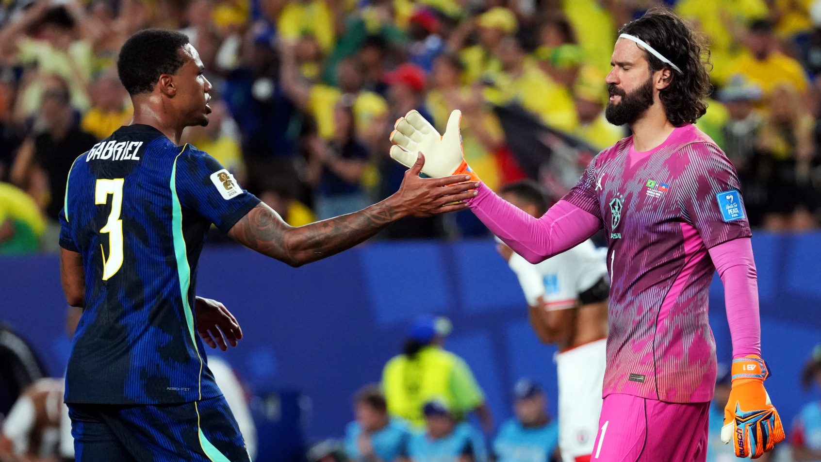 Gabriel Magalhaes and Alisson Becker congratulating each other