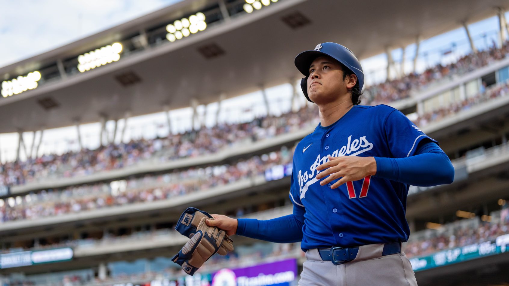 Shohei Ohtani scores a run in a game versus the Twins.
