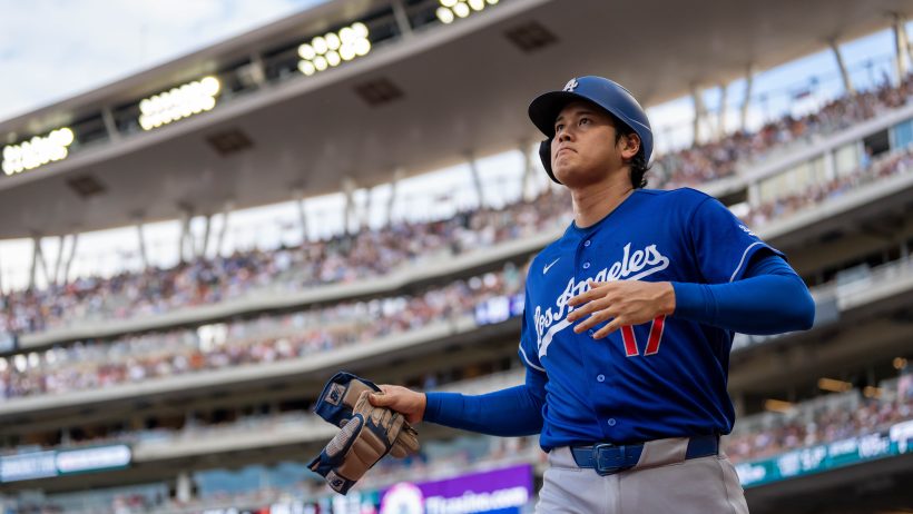 Shohei Ohtani scores a run in a game versus the Twins.