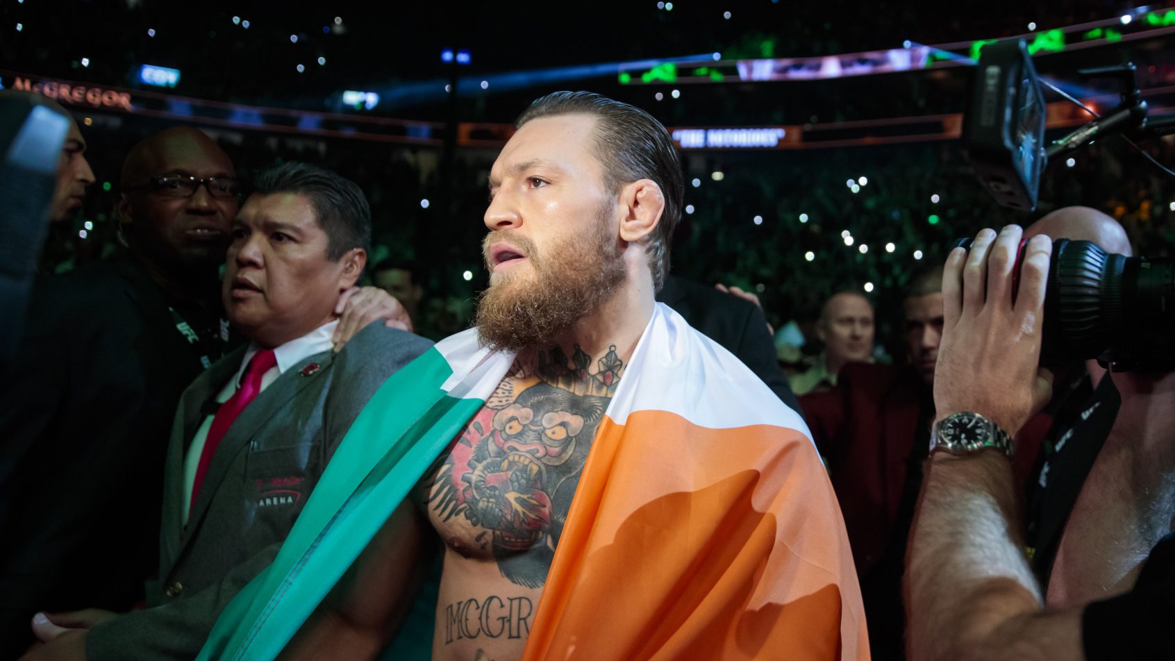 January 18, 2020; Las Vegas, Nevada, USA; Conor McGregor holds an Irish flag as he celebrates his first round TKO victory against Donald Cerrone following UFC 246 at T-Mobile Arena. Mandatory Credit: Mark J. Rebilas-Imagn Images