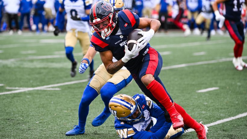 Tyson Philpot gets tackled after hauling in a catch versus Winnipeg.