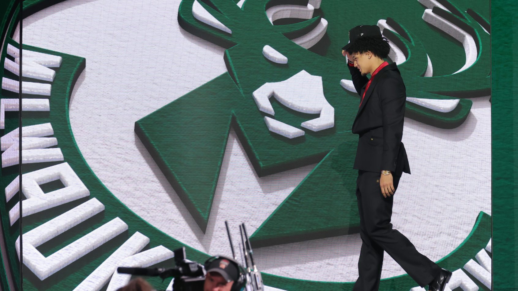 Brayden Burries walks across the stage after being drafted by the Milwaukee Bucks.