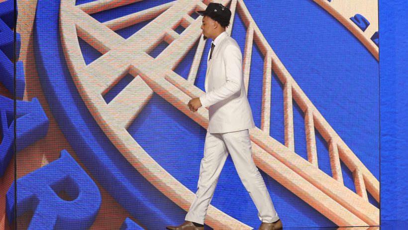 Yaxel Lendeborg walks across the stage after being drafted by the Golden State Warriors.