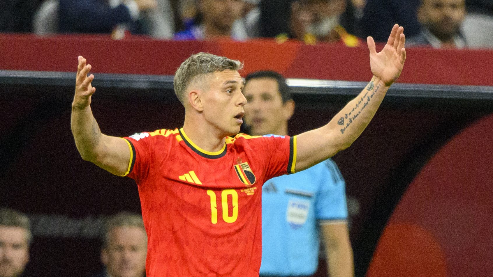 Belgium forward Leandro Trossard gesturing to the referee
