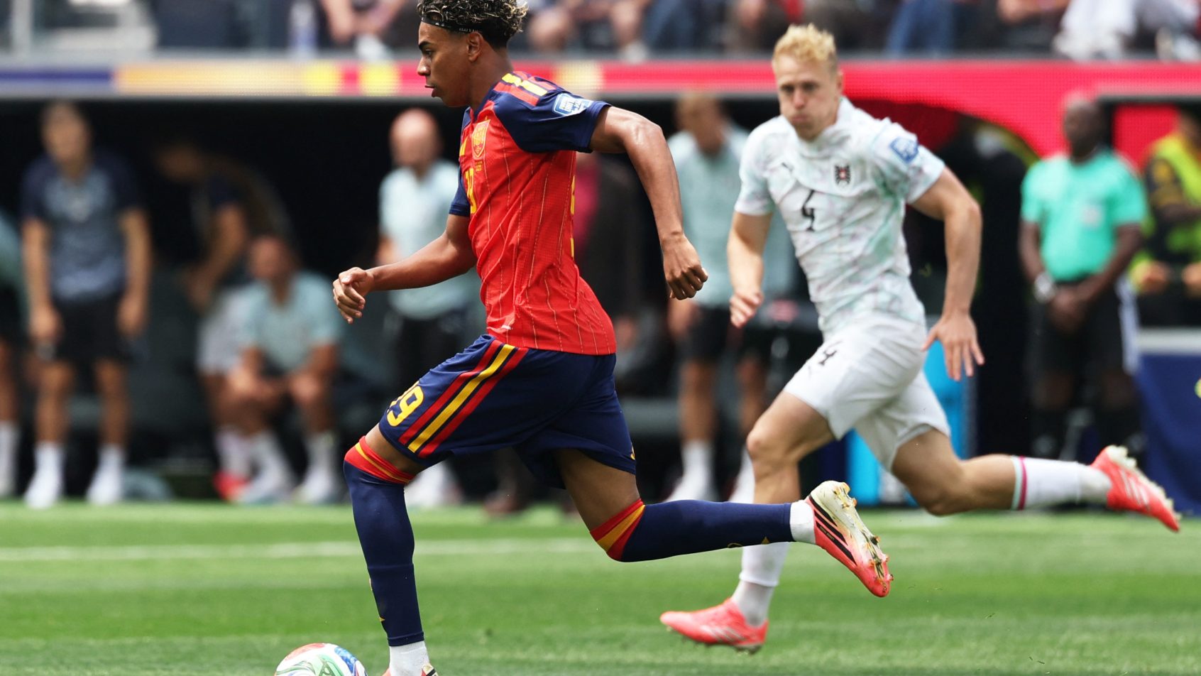 Spain's Lamine Yamal running with the ball