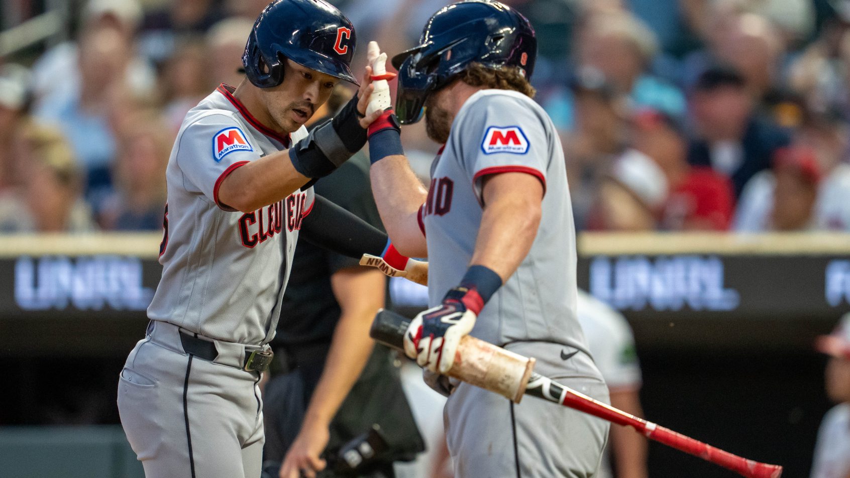 The Guardians celebrate at home plate vs the Twins.