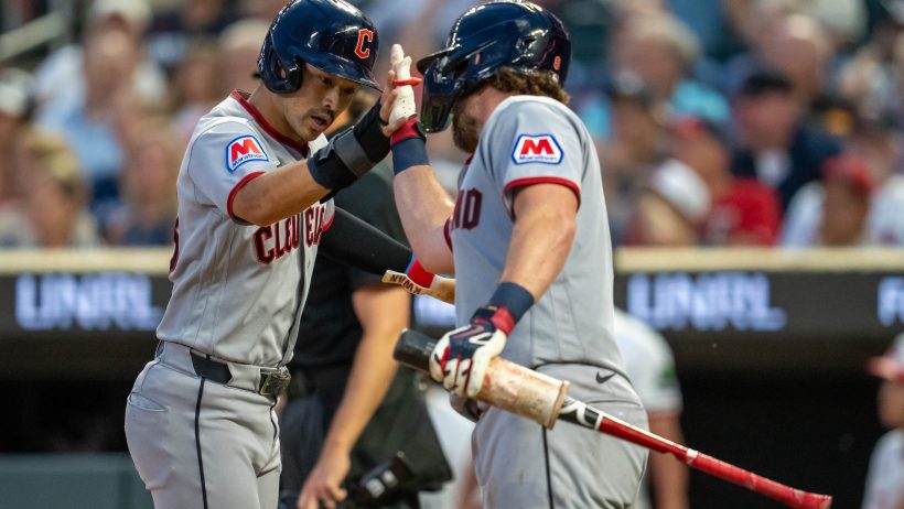 The Guardians celebrate at home plate vs the Twins.
