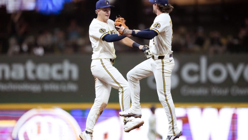 Cooper Pratt high fives second baseman Brice Turang