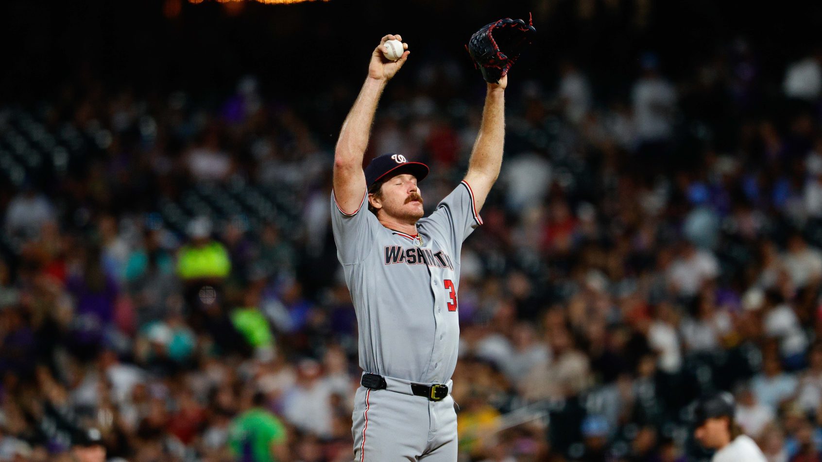 Miles Mikolas stretching arms over head on mound