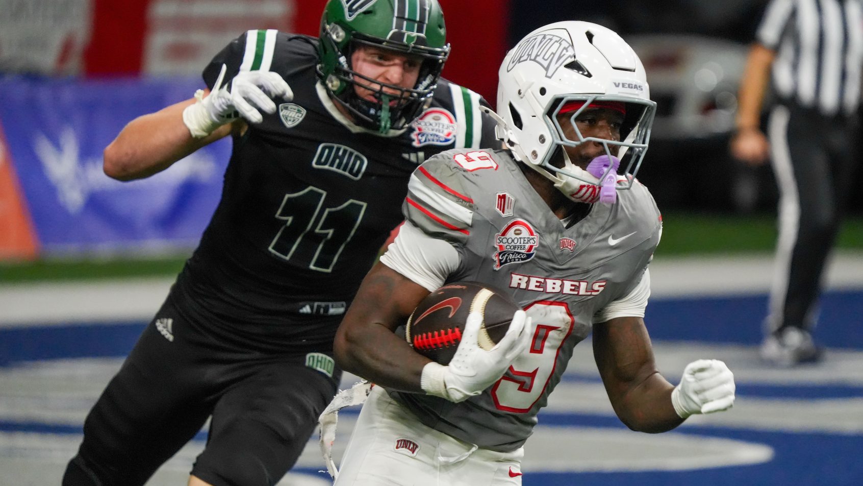 Rebels running back Jai'Den Thomas carries the ball