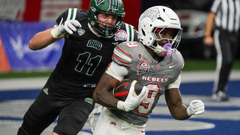 Rebels running back Jai'Den Thomas carries the ball