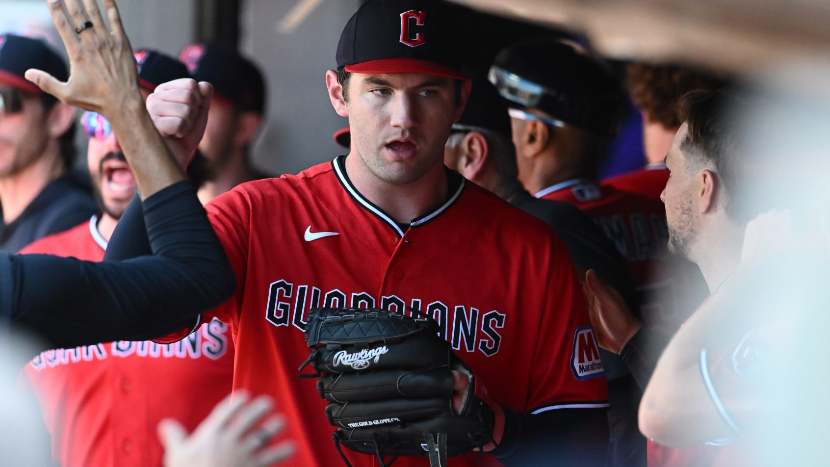 Gavin Williams high-fives in dugout
