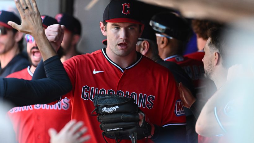 Gavin Williams high-fives in dugout