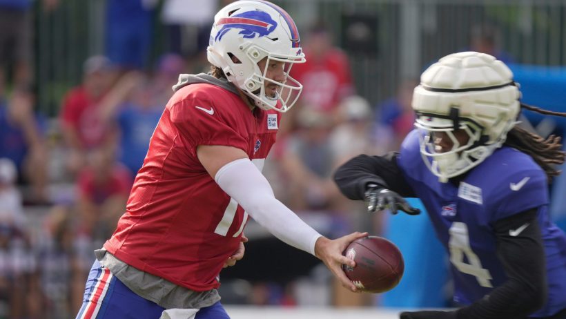 Josh Allen hands off to James Cook in practice.