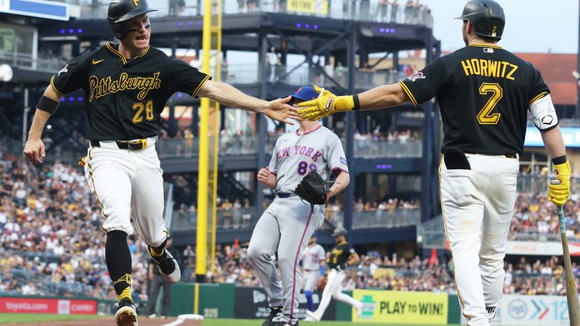 The Pirates celebrate a run versus the Mets.