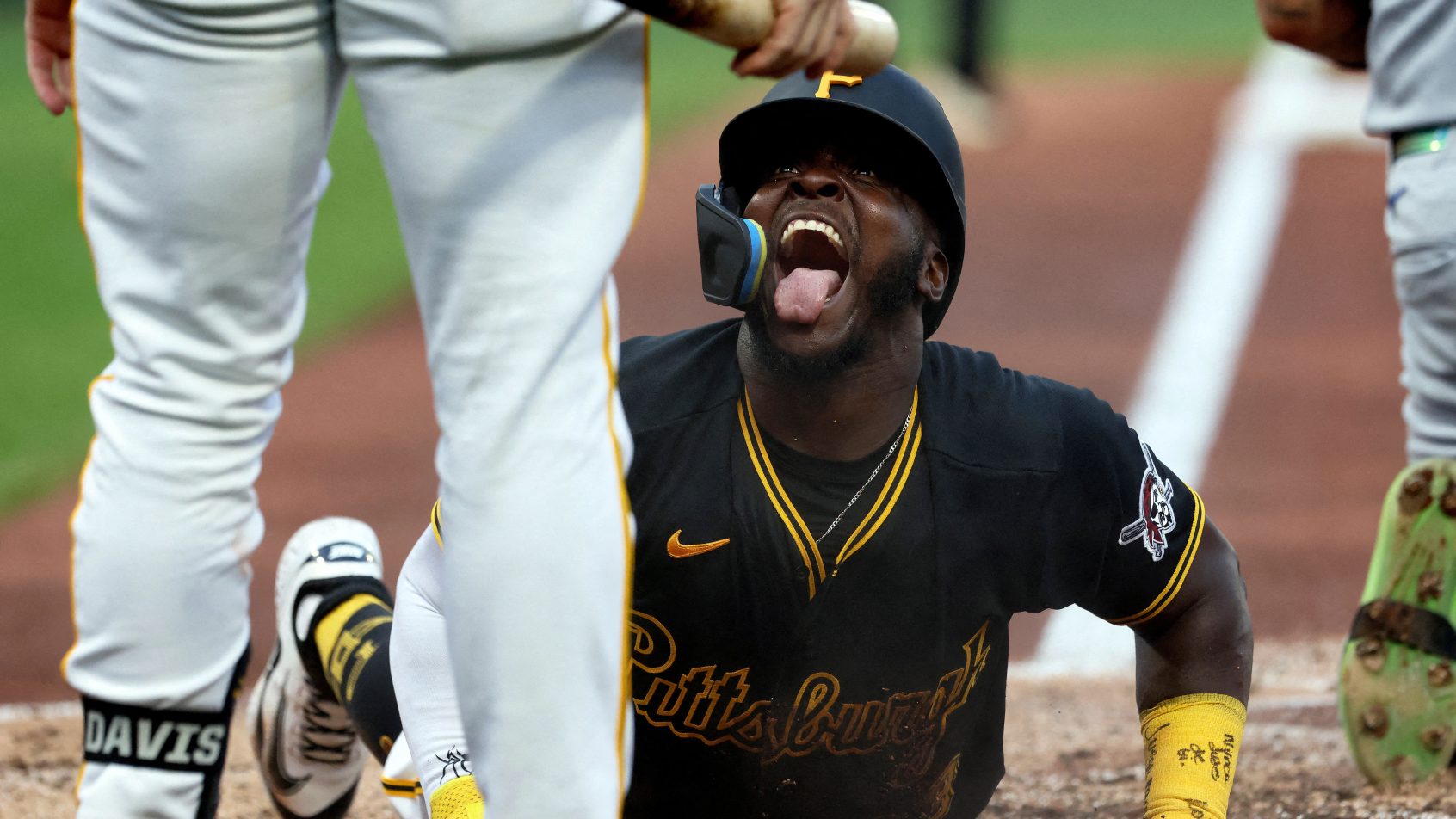 Ronny Simon slides in safely to score a run for the Pirates.
