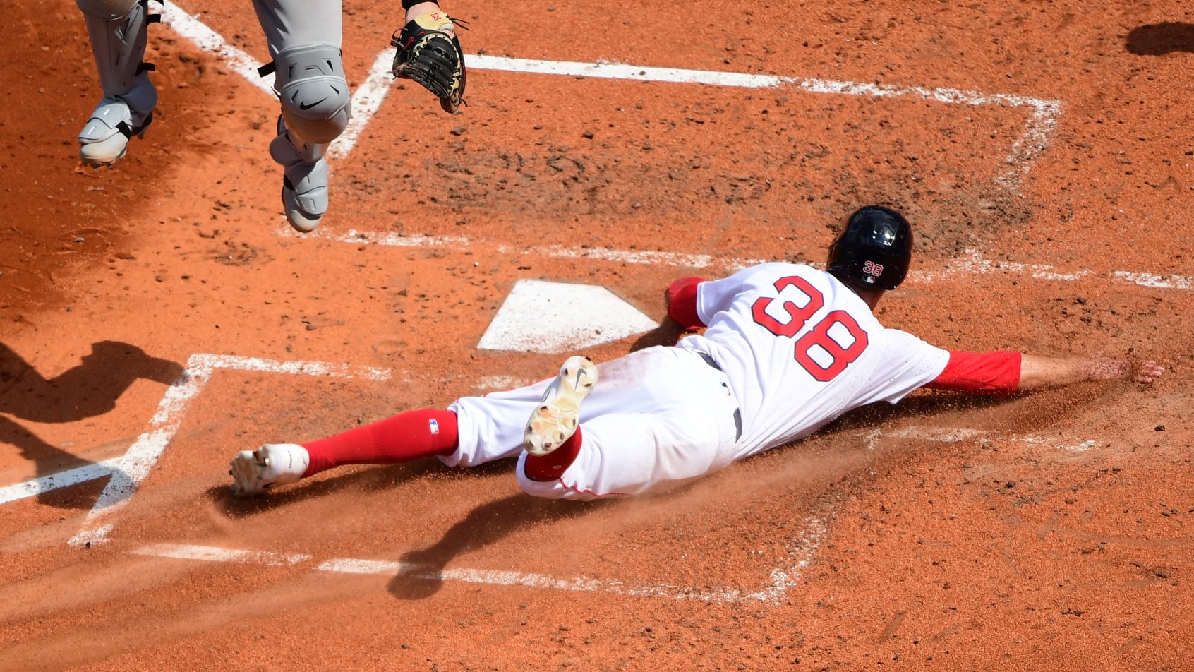 Eli White slides home safely versus the Athletics.