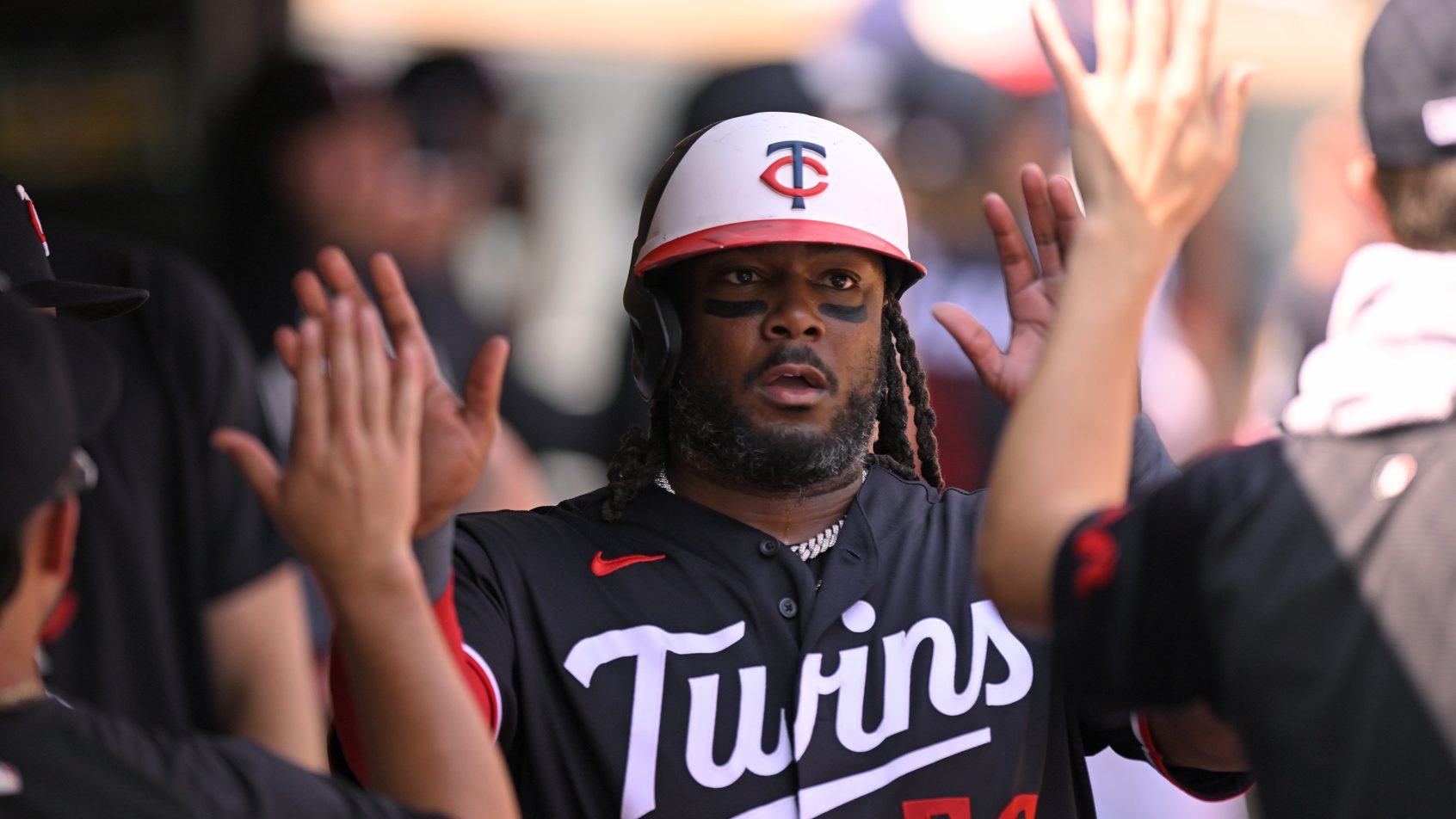 Josh Bell celebrates in the Twins dugout.