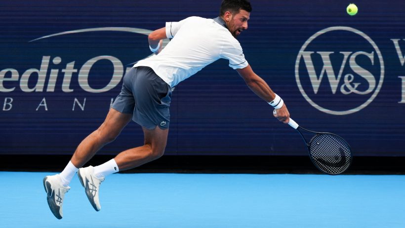 Novak Djokovic stretches for a backhand