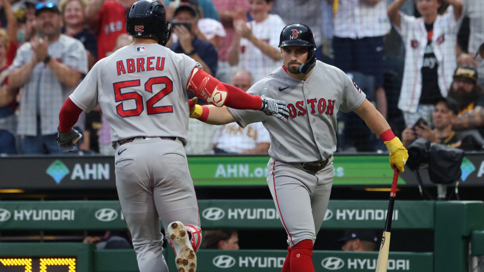 The Red Sox celebrate a run against the Pirates.