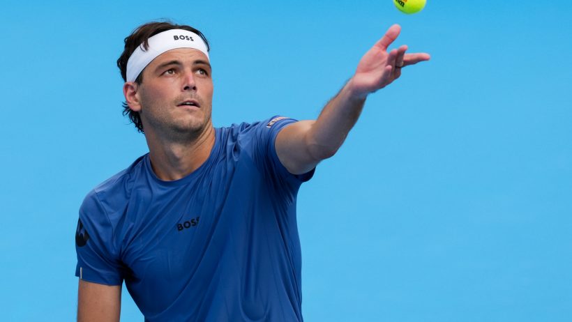 Taylor Fritz tossing ball to serve