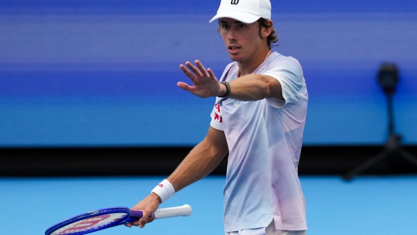 Alex de Minaur raising hand in reaction