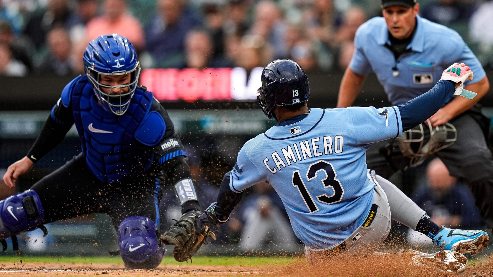 Junior Caminero slides into home plate vs the Tigers.