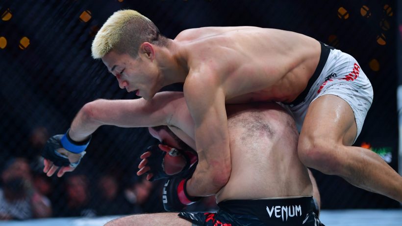Rinya Nakamura controls Muin Gafurov during a UFC 311 fight.