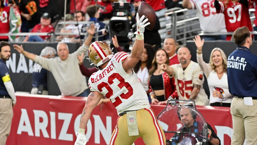 Christian McCaffrey spikes the ball.