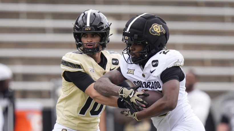 Julian Lewis hands the ball off during a Colorado spring game.