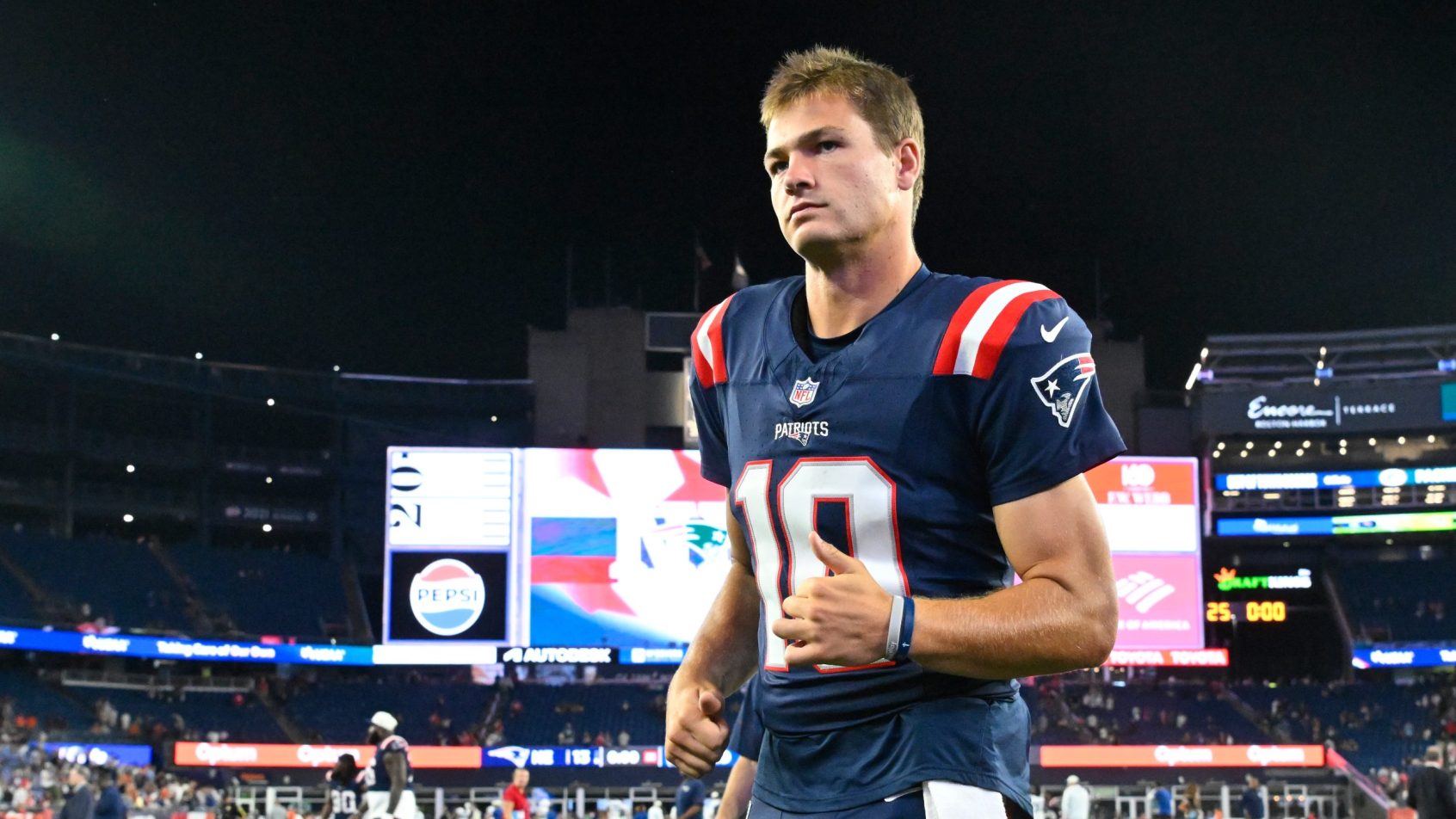 Drake Maye jogs off the field after a Patriots preseason game.