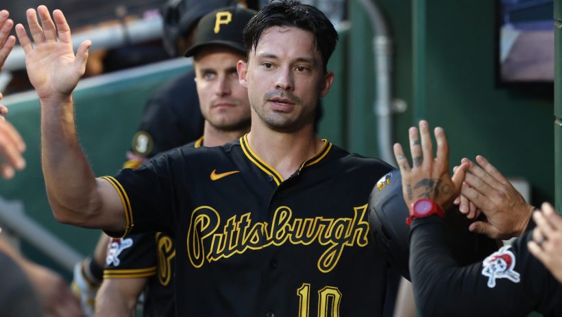 Bryan Reynolds high fives his teammates in the dugout.