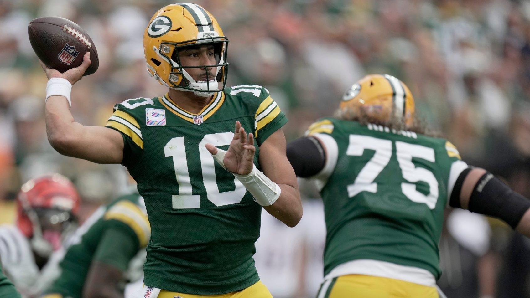 Green Bay Packers quarterback Jordan Love throwing a pass