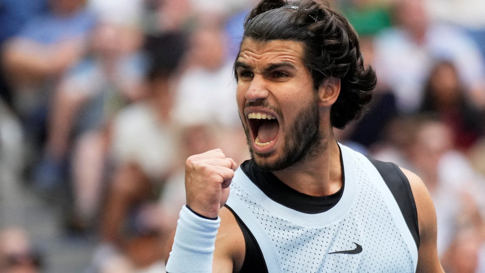 Carlos Alcaraz celebrates during a US Open victory over Tommy Paul.
