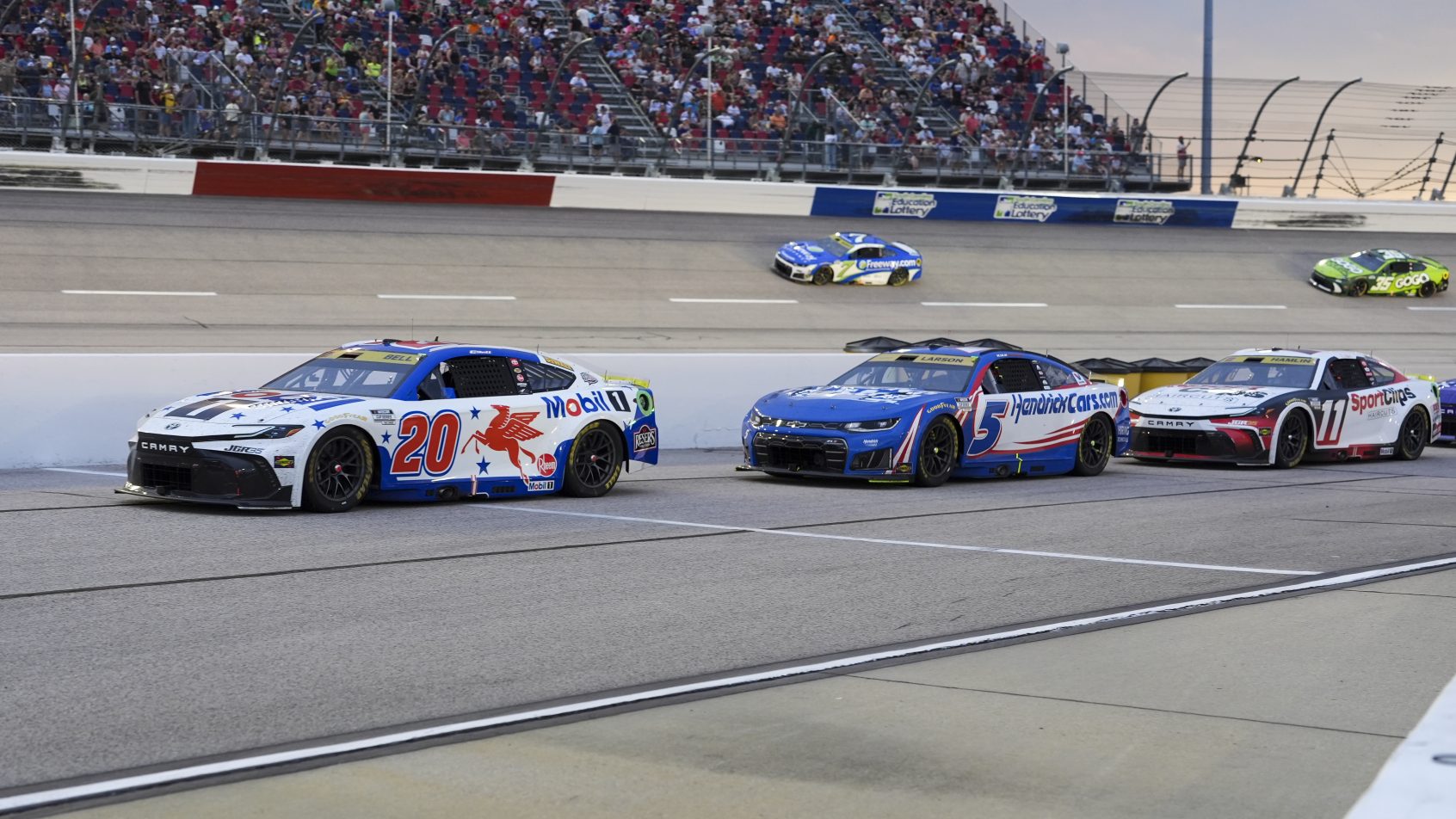 Christopher Bell, Kyle Larson, and Denny Hamlin on-track in Darlington (2026).