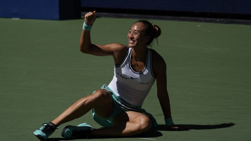 Qinwen Zheng fist pump sitting on court