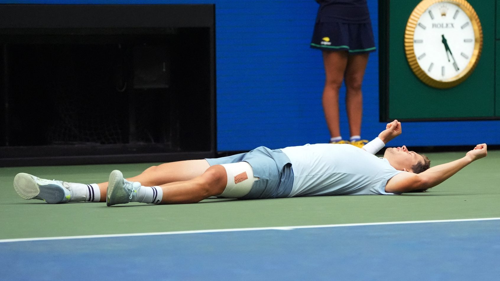 Alexander Blockx laying on ground celebrating