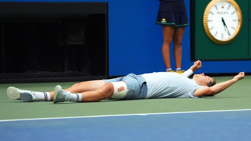 Alexander Blockx laying on ground celebrating